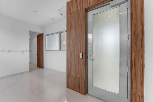 a bedroom with a large bed and a large window