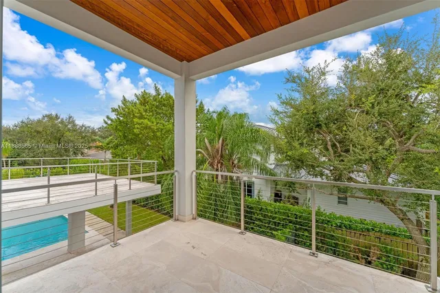 a view of swimming pool with a yard and large tree