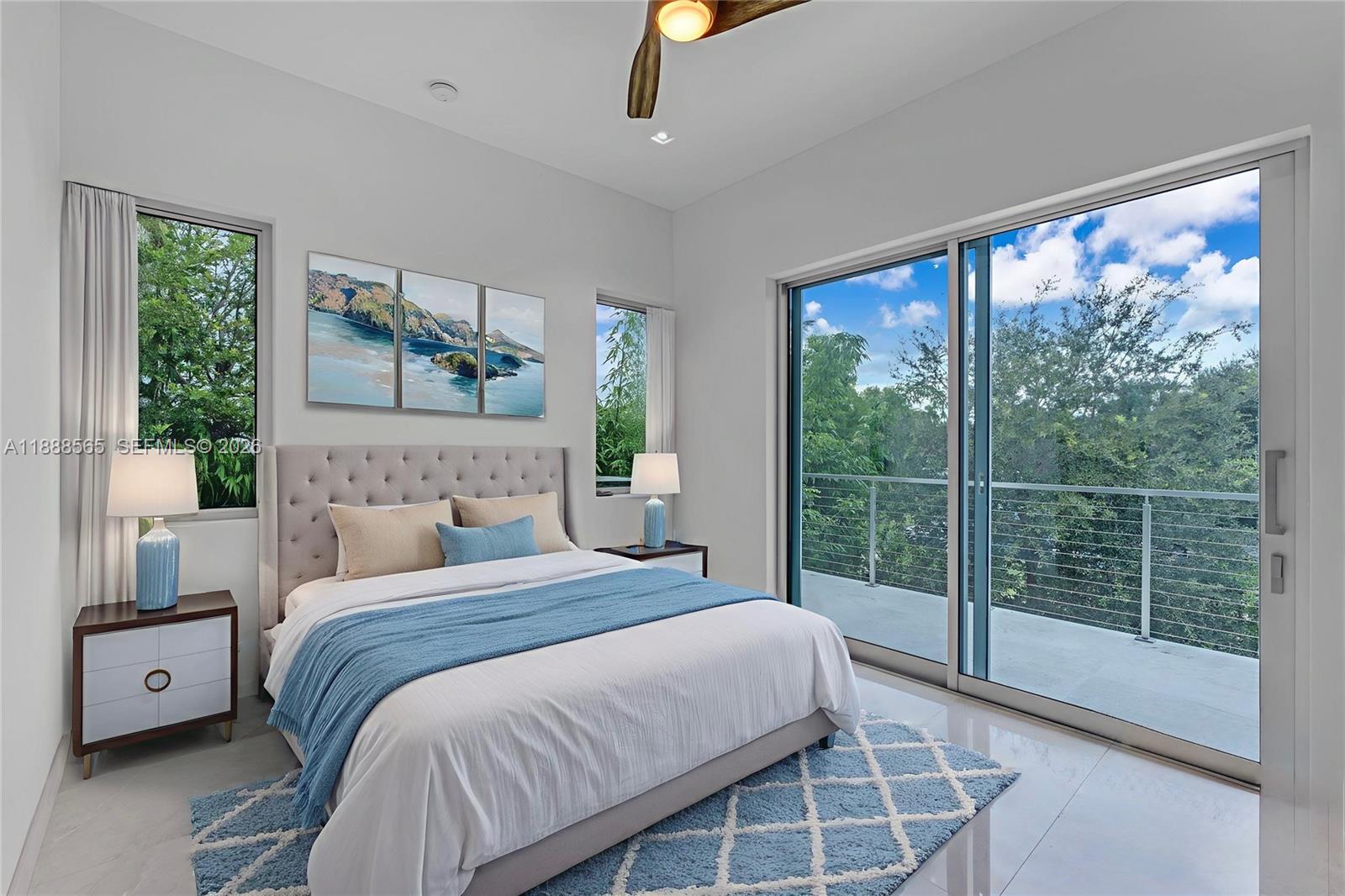 9101 Southwest 69th Court Pinecrest, FL 33156 - Photo 58 of 69 a bedroom with a large bed and a large window