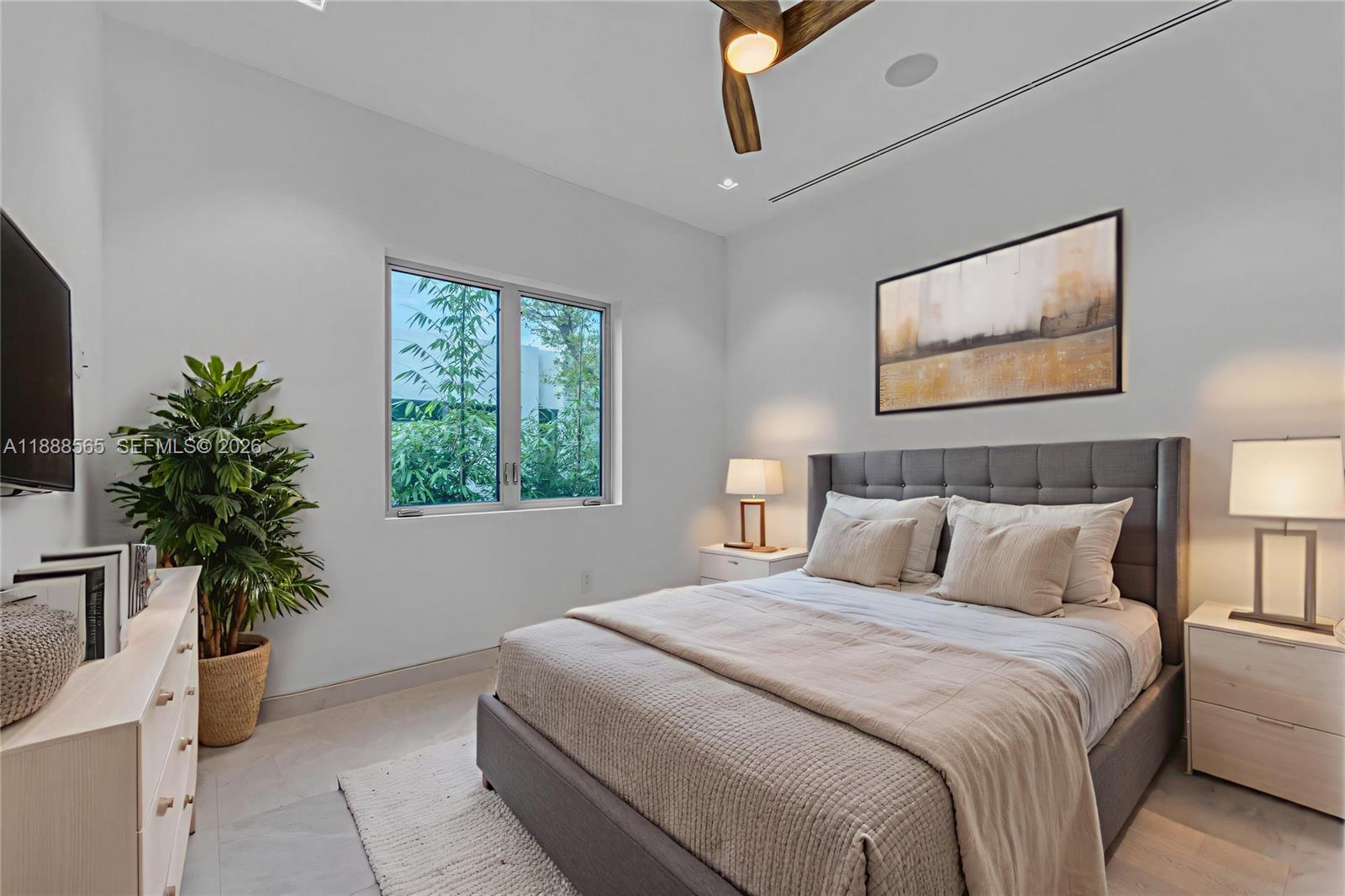 9101 Southwest 69th Court Pinecrest, FL 33156 - Photo 60 of 69 a bedroom with bed and a potted plant