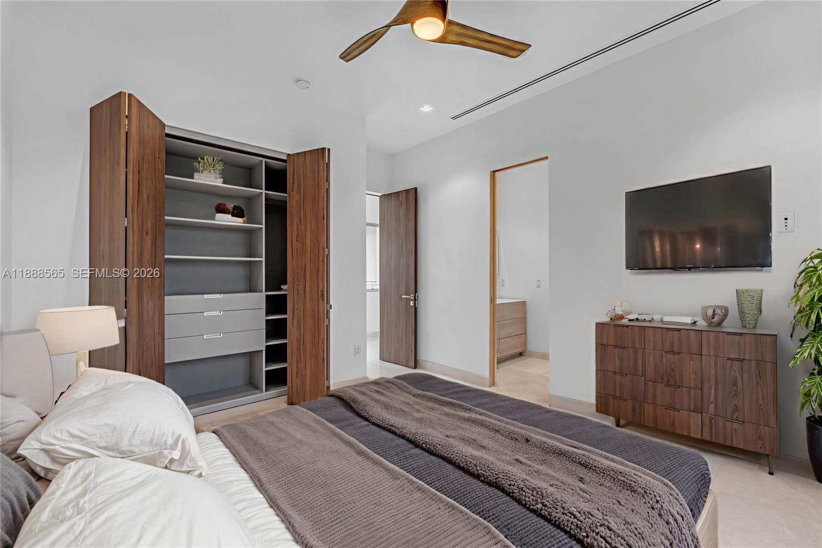 9101 Southwest 69th Court Pinecrest, FL 33156 - Photo 62 of 69 a bedroom with a bed and flat screen tv