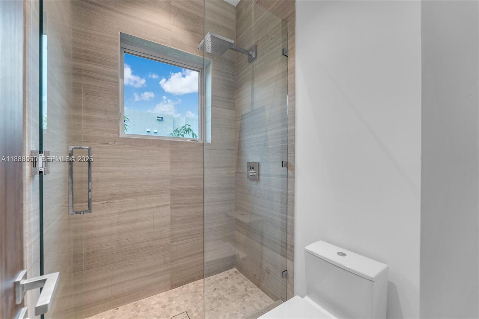 9101 Southwest 69th Court Pinecrest, FL 33156 - Photo 63 of 69 a bathroom with a toilet and a shower