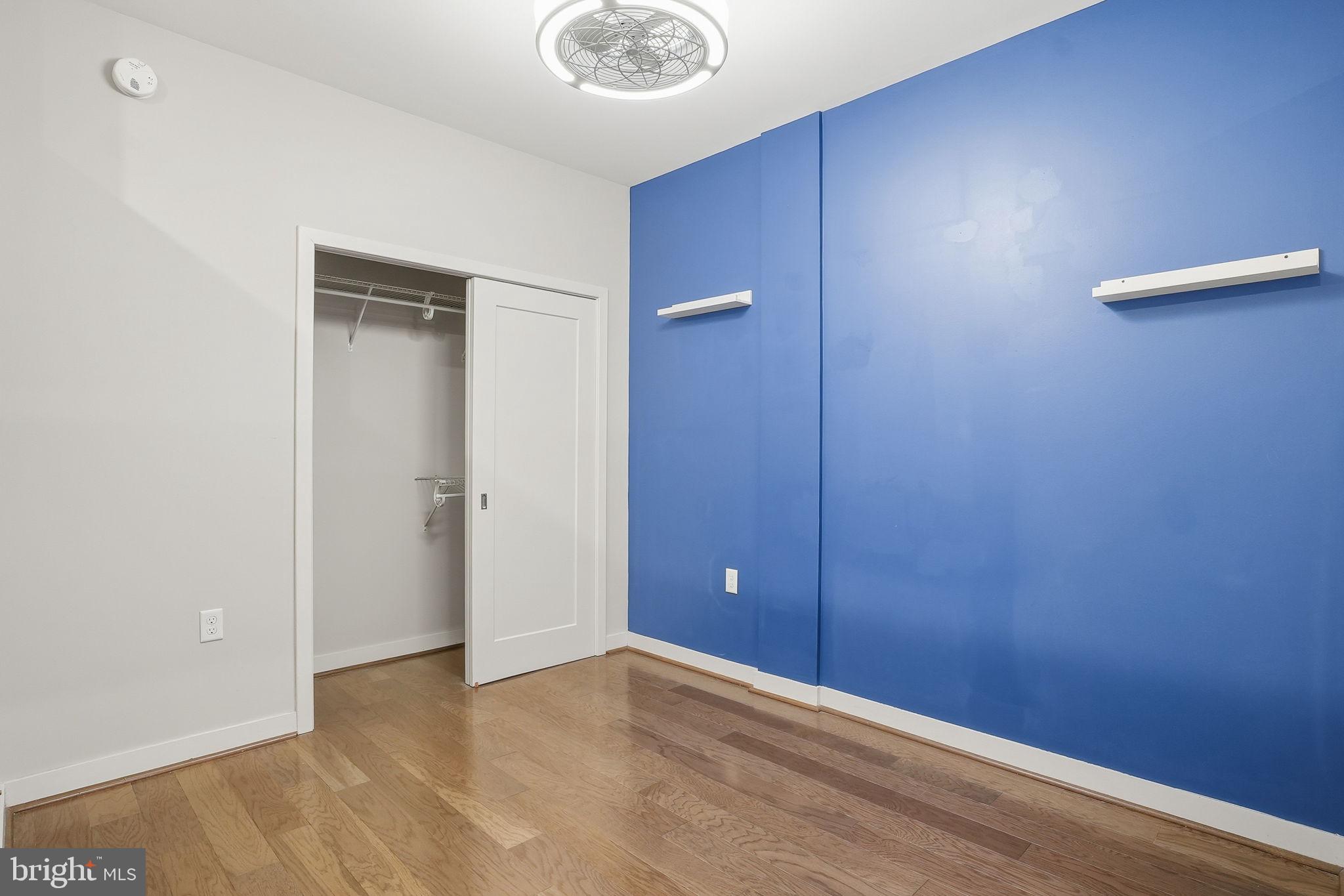 1320 Fenwick Lane, Unit 210 Silver Spring, MD 20910 - Photo 11 of 29 an empty room with closet and mirror