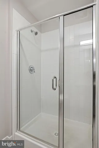 a bathroom with a glass shower door