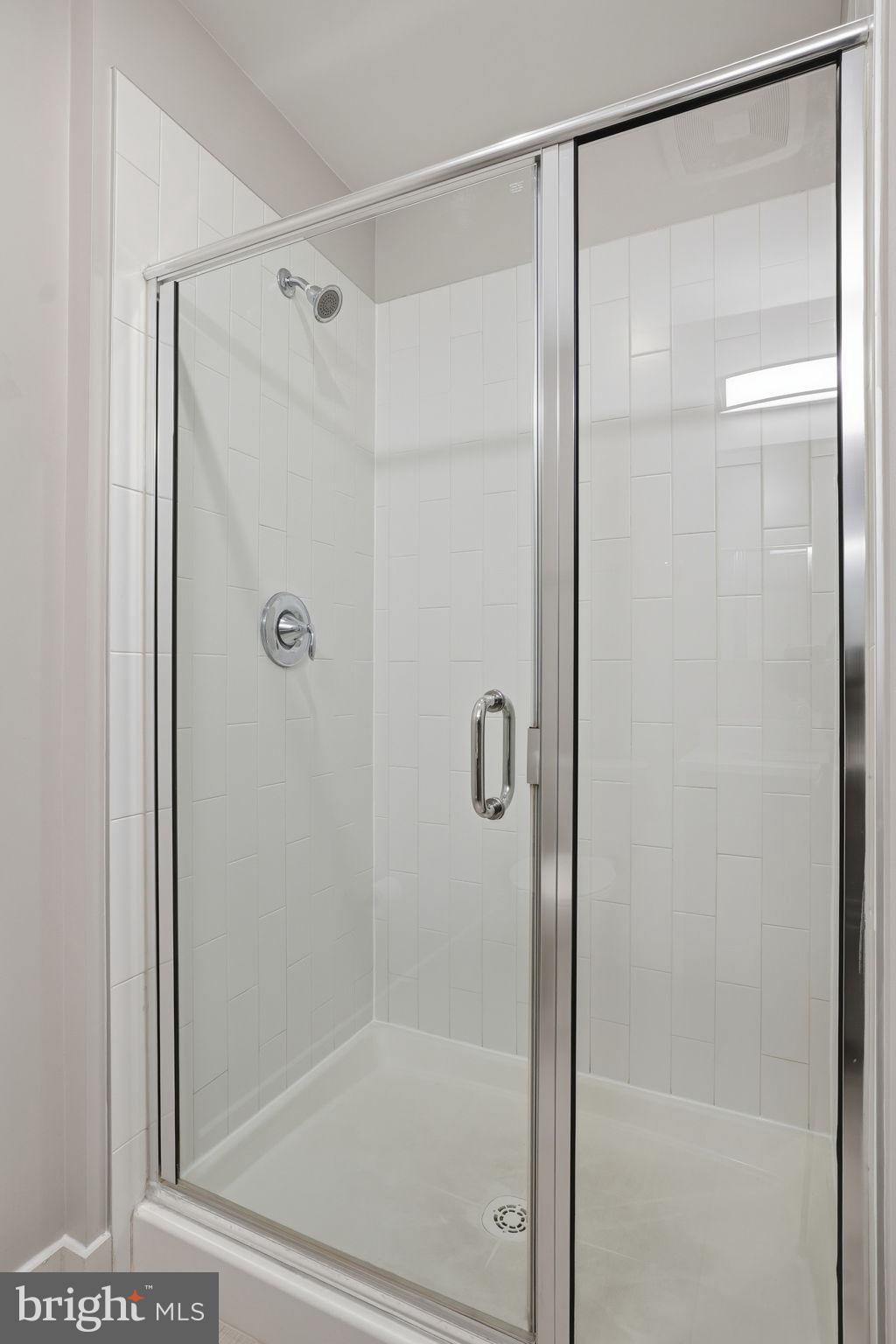 1320 Fenwick Lane, Unit 210 Silver Spring, MD 20910 - Photo 14 of 29 a bathroom with a glass shower door