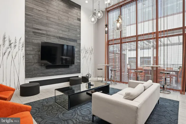 an outdoor sitting area with furniture and wooden floor