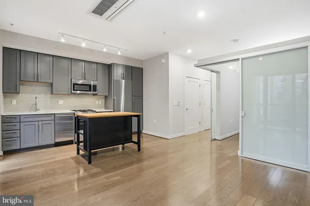 a kitchen with a refrigerator and a sink