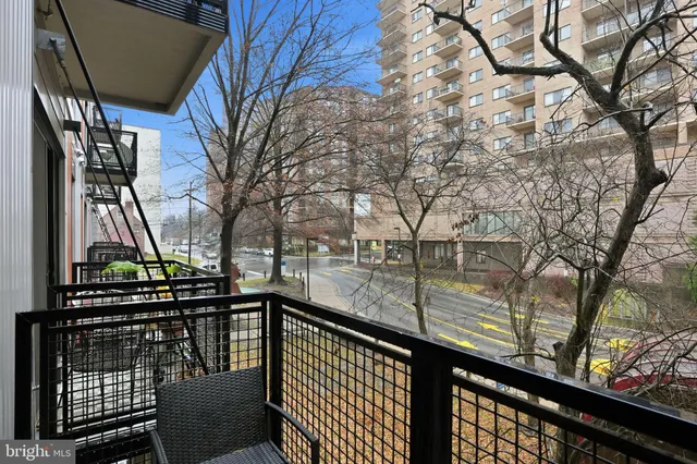 a view of balcony with wooden floor and fence