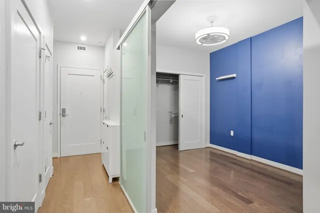 a view of hallway with wooden floor