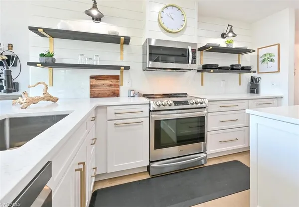 a kitchen with a sink stove and cabinets