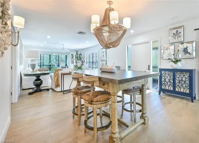 a kitchen with stainless steel appliances kitchen island granite countertop a table and chairs