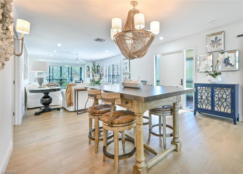 3105 Riviera Drive, Unit A201 Naples, FL 34103 - Photo 17 of 30 a view of a dining room with furniture