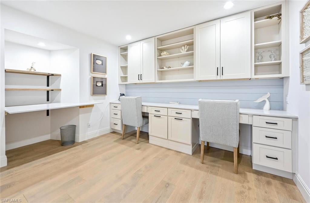 3105 Riviera Drive, Unit A201 Naples, FL 34103 - Photo 20 of 30 a kitchen with a stove cabinets and wooden floor