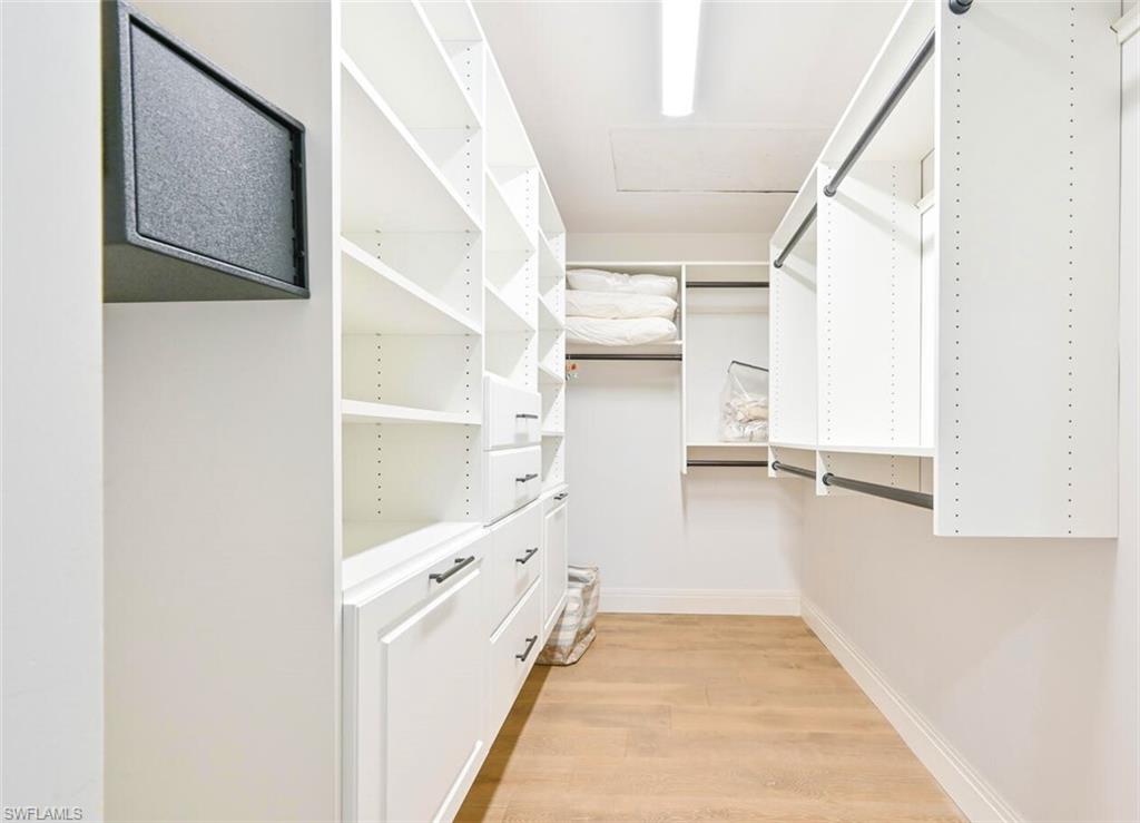 3105 Riviera Drive, Unit A201 Naples, FL 34103 - Photo 23 of 30 a view of walk in closet with empty racks