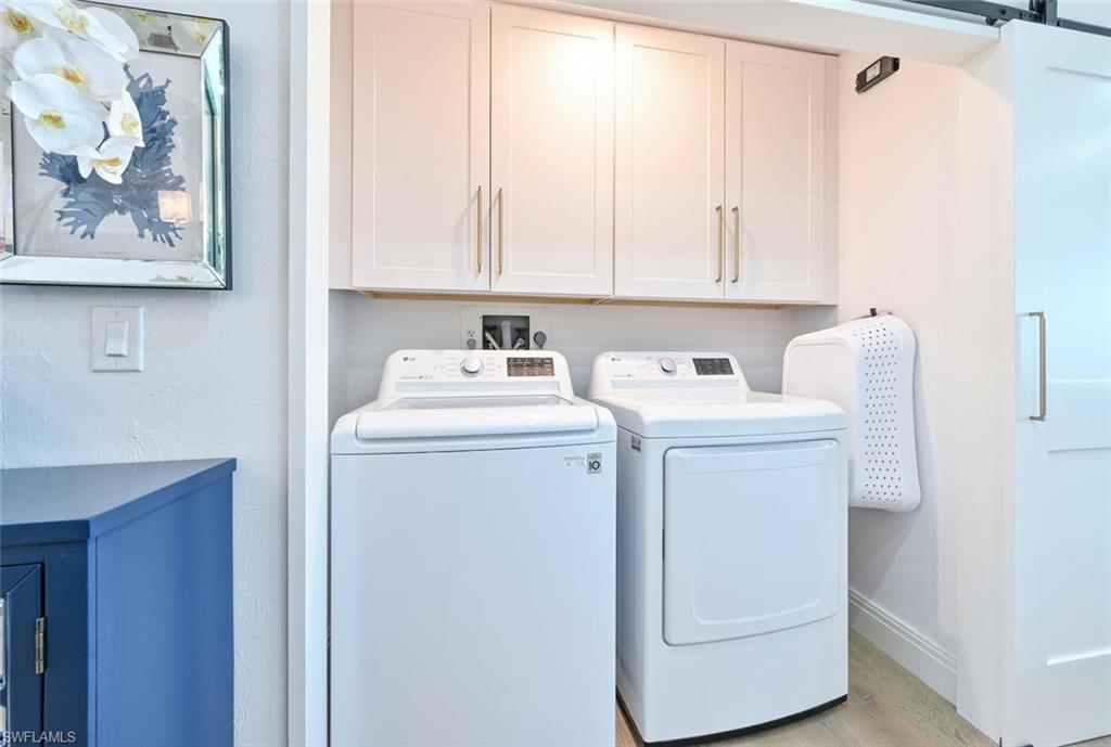 3105 Riviera Drive, Unit A201 Naples, FL 34103 - Photo 28 of 30 a utility room with dryer and washer
