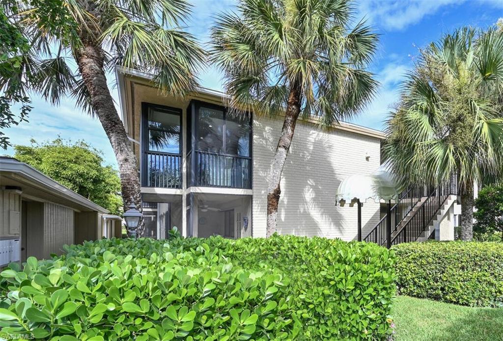 3105 Riviera Drive, Unit A201 Naples, FL 34103 - Photo 3 of 30 a front view of a house with a yard