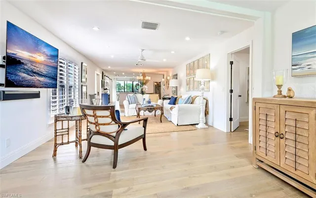 a living room with furniture and a dining table with kitchen view