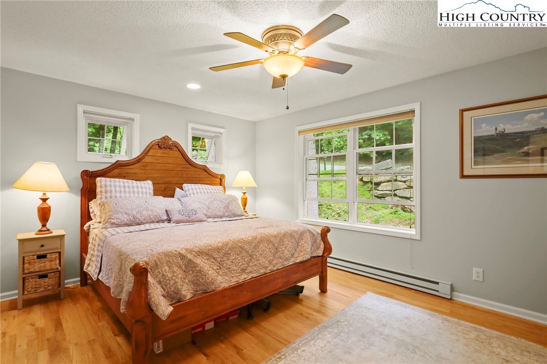 920-918 Pine Ridge Road Beech Mountain, NC 28604 - Photo 20 of 39 a bedroom with a bed and a chandelier