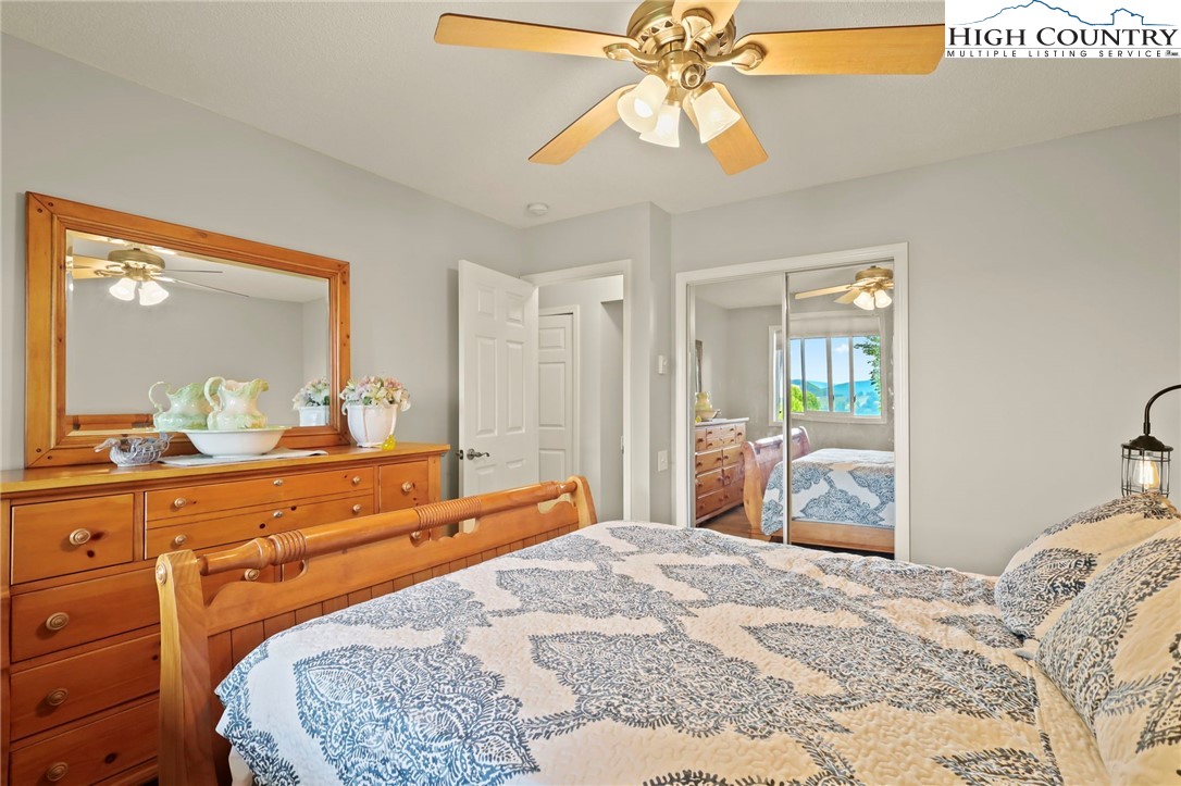 920-918 Pine Ridge Road Beech Mountain, NC 28604 - Photo 30 of 39 a bedroom with a bed and a chandelier