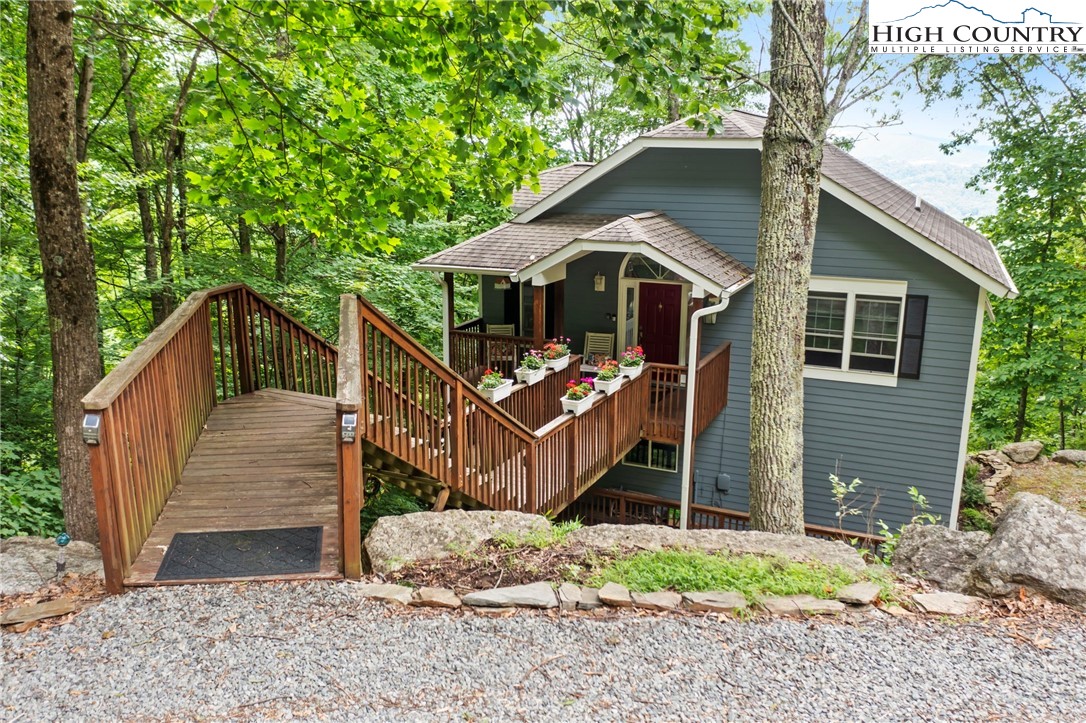 920-918 Pine Ridge Road Beech Mountain, NC 28604 - Photo 3 of 39 a front view of a house with a yard