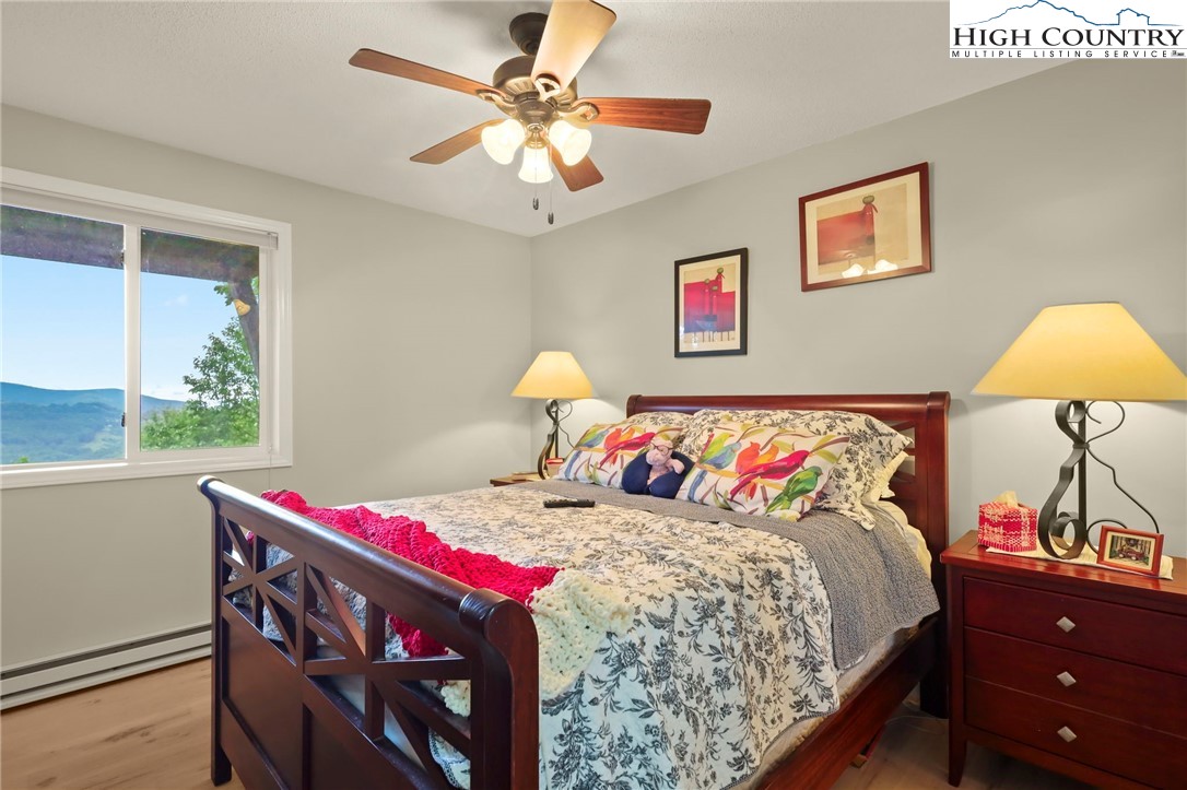 920-918 Pine Ridge Road Beech Mountain, NC 28604 - Photo 33 of 39 a bedroom with a bed and a chandelier