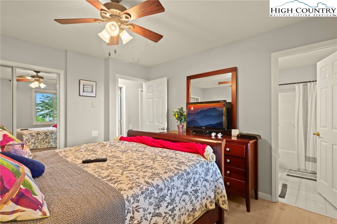 920-918 Pine Ridge Road Beech Mountain, NC 28604 - Photo 34 of 39 a bedroom with a bed and a flat screen tv