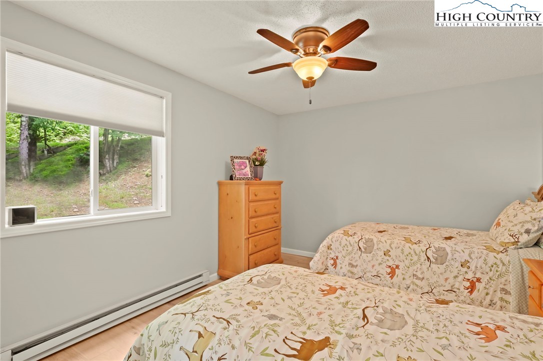 920-918 Pine Ridge Road Beech Mountain, NC 28604 - Photo 38 of 39 a bedroom with a bed and a large window