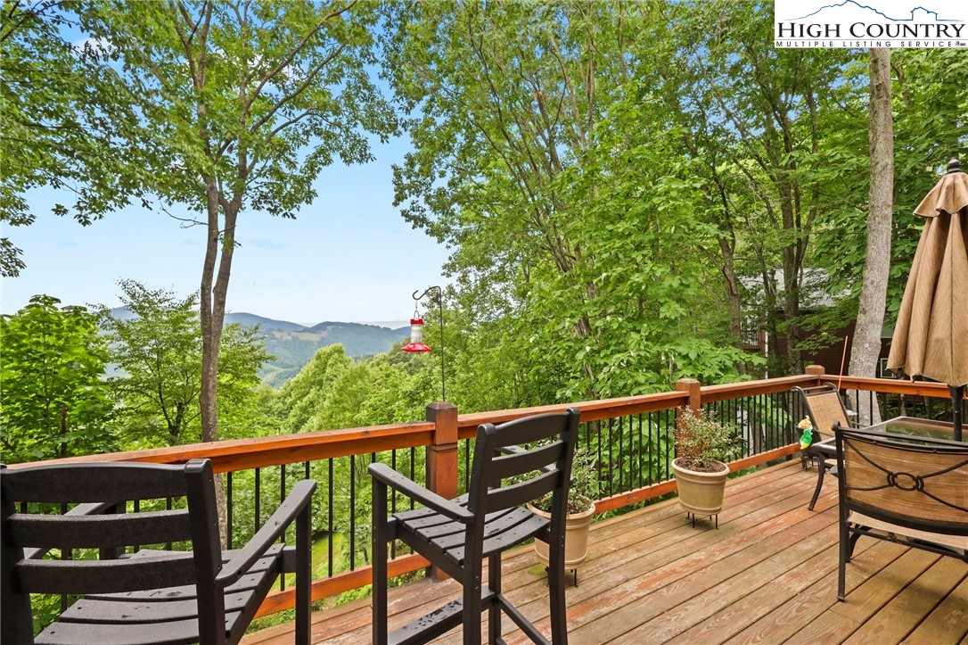 920-918 Pine Ridge Road Beech Mountain, NC 28604 - Photo 8 of 39 a view of a balcony with wooden floor and fence