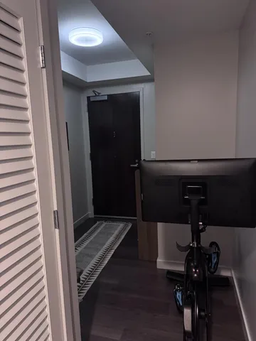 a view of hallway with wooden floor