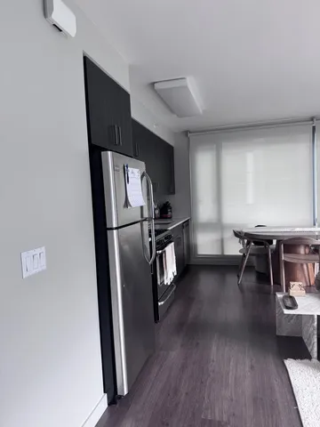 a view of a refrigerator in kitchen and dining room