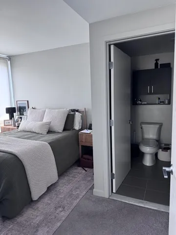 a bedroom with a bed and a view of bathroom