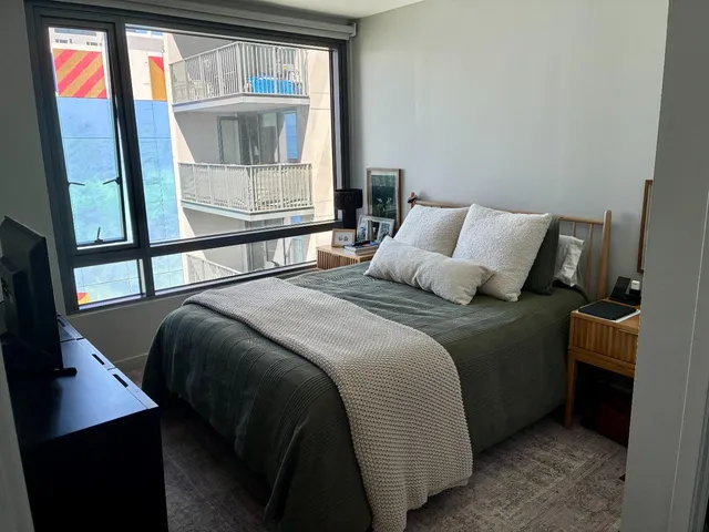 a bedroom with a bed and window