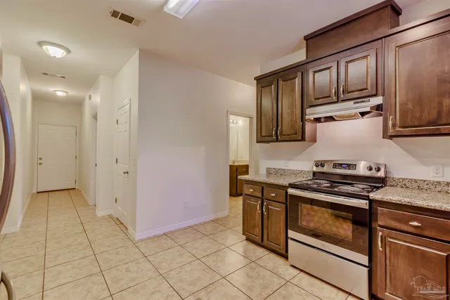 an empty room with windows and fireplace