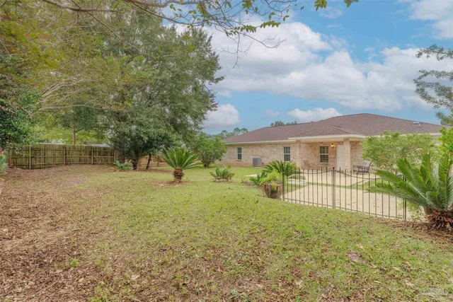a view of a house with backyard and sitting area