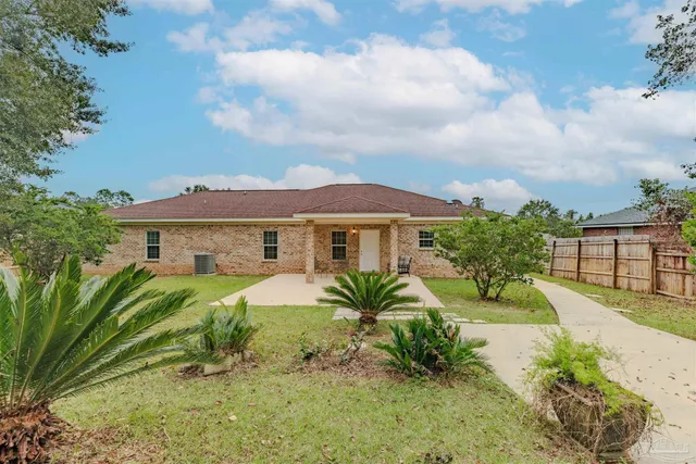 a front view of a house with yard patio and green space