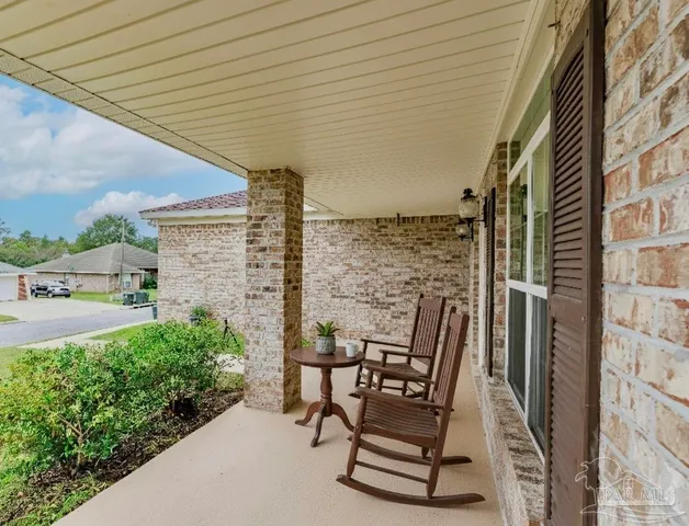 a view of patio with table and chairs and potted plants