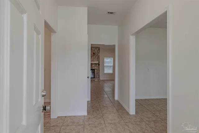 a view of a hallway with wooden shelves