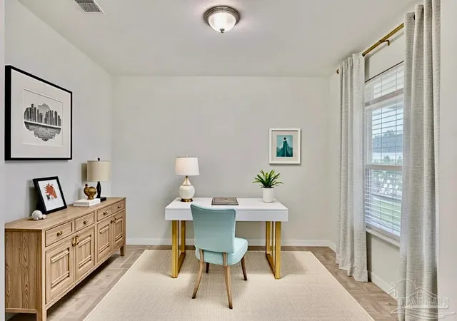 a view of a dining room with furniture and a window