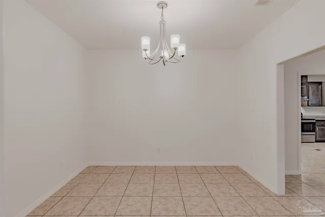 a dining room with furniture and chandelier