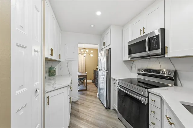 a kitchen with a refrigerator stove and microwave