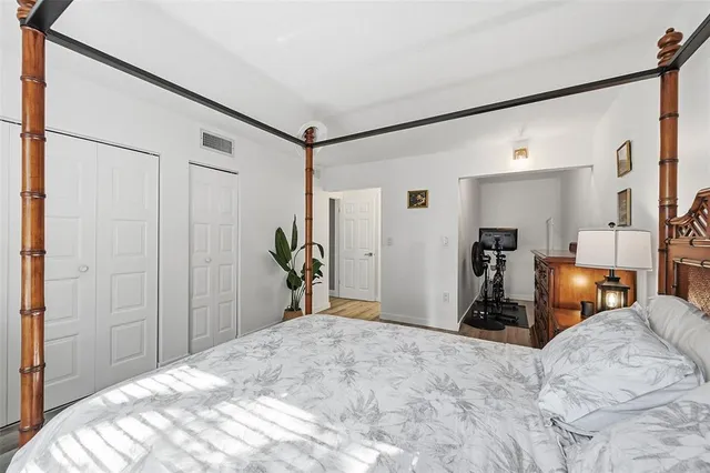 a bedroom with bed and ceiling fan
