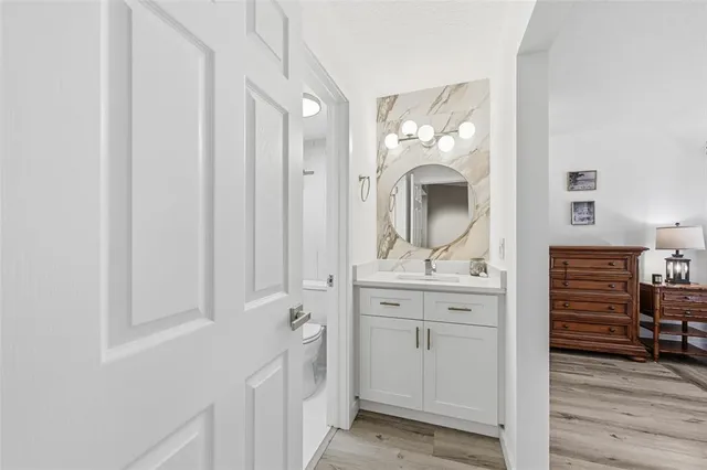 a bathroom with a sink a mirror and a vanity