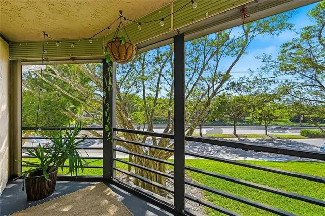 a view of a yard with wooden fence