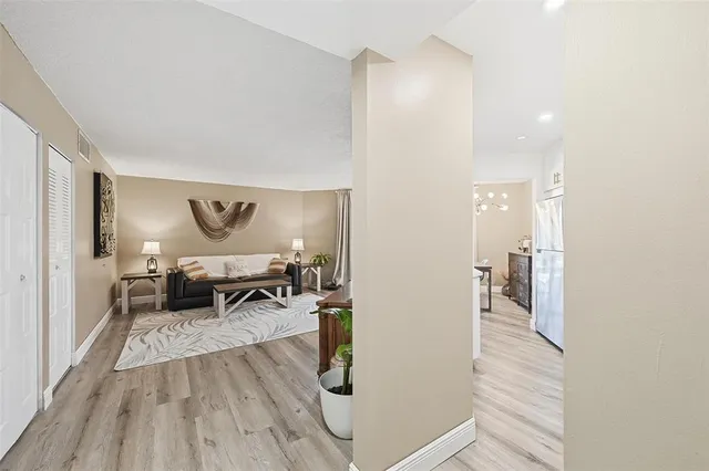 a living room with furniture and a wooden floor