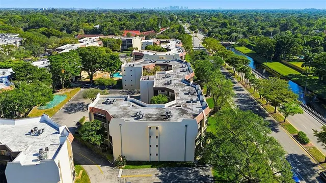 an aerial view of residential house with outdoor space and trees