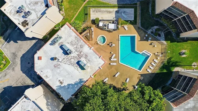 an aerial view of a house with a yard and wooden deck
