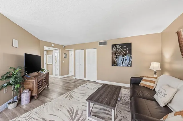 a bedroom with furniture and a flat screen tv