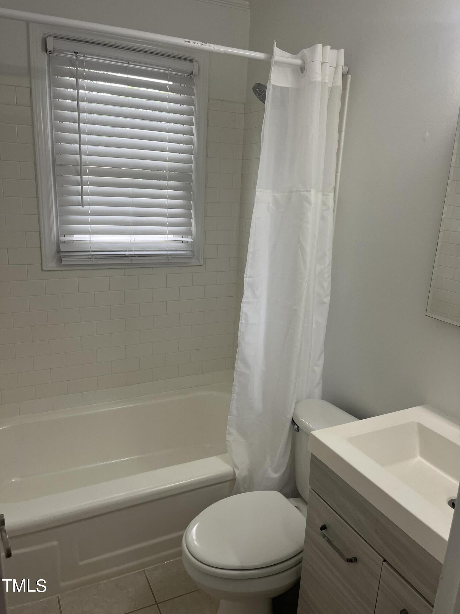 2626 McNeil Street Raleigh, NC 27608 - Photo 11 of 15 a white toilet sitting next to a bath tub