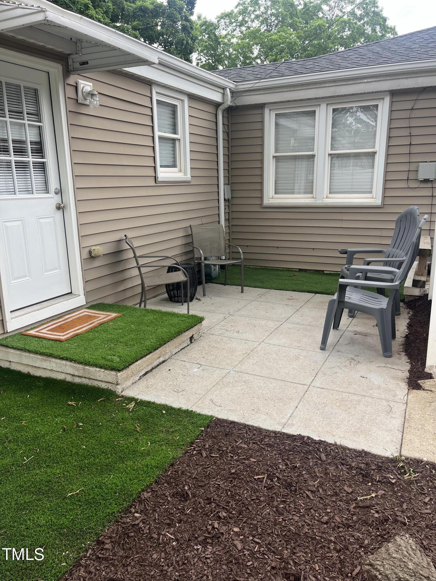 2626 McNeil Street Raleigh, NC 27608 - Photo 12 of 15 a backyard of a house with outdoor seating