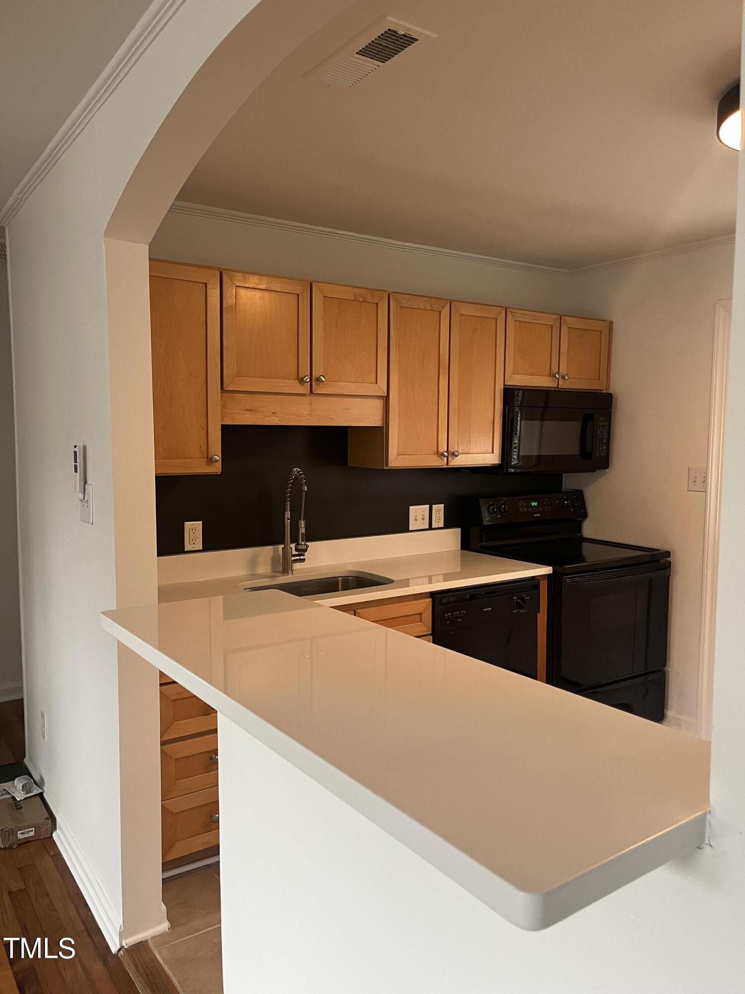 2626 McNeil Street Raleigh, NC 27608 - Photo 3 of 15 a kitchen with stainless steel appliances a sink a stove a microwave a refrigerator and cabinets